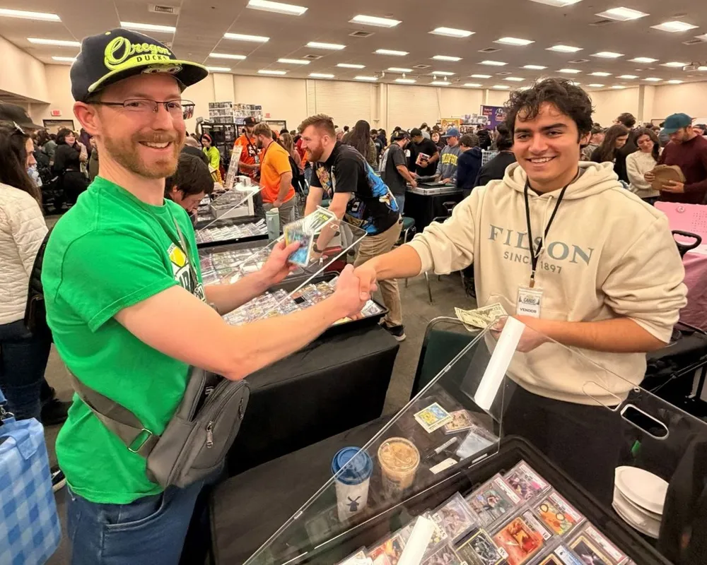 A collector and a vendor shaking hands over a deal at the show